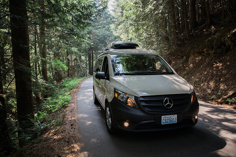 Mercedes metric camper van driving up mountain road