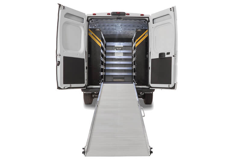 White vocational van with open rear doors and an extended metal ramp leading into a shelved cargo area, expertly designed for a plumber on the go. White vocational van with open rear doors and an extended metal ramp leading into a shelved cargo area, expertly designed for a plumber on the go.