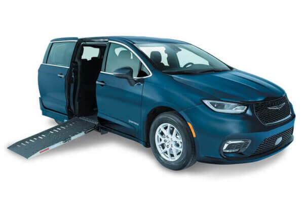 The Chrysler Pacifica minivan features an extended wheelchair ramp from the passenger side, showcasing excellent accessibility features.