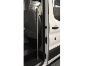 Open passenger side door of a white vehicle with a metal grab bar installed next to the seat, covered in plastic.