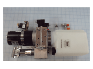 A hydraulic pump assembly with an electric motor, metal mounting bracket, fluid reservoir, and attached valves on a grid-patterned background.