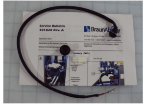 A black electrical harness is placed on top of a BraunAbility service bulletin document labeled 401828 Rev. A for NCL and NCL QPA lifts.