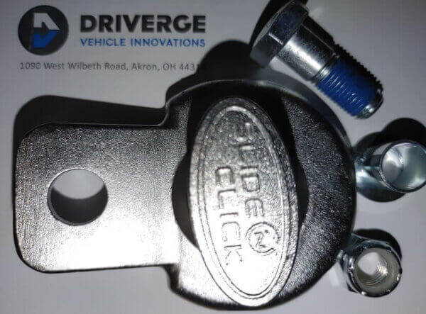 A metal Slide Click latch with bolts and nuts is placed on a surface with the Diverge Vehicle Innovations logo and address printed on it.