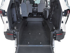Rear-Entry view of a Toyota Sienna Hybrid wheelchair-accessible van, featuring a lowered floor and ramp, two front seats, and an open space for wheelchair placement.