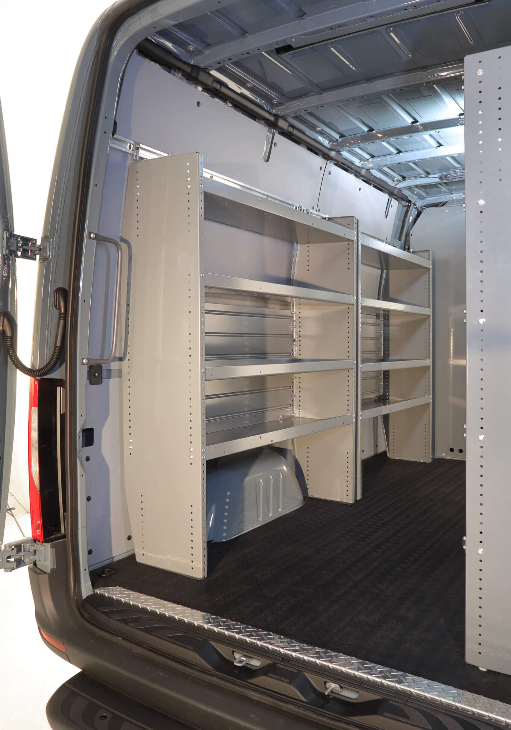The interior of the vocational van features metal shelving units installed for organized storage, ideal for HVAC tools and equipment. The interior of the vocational van features metal shelving units installed for organized storage, ideal for HVAC tools and equipment.