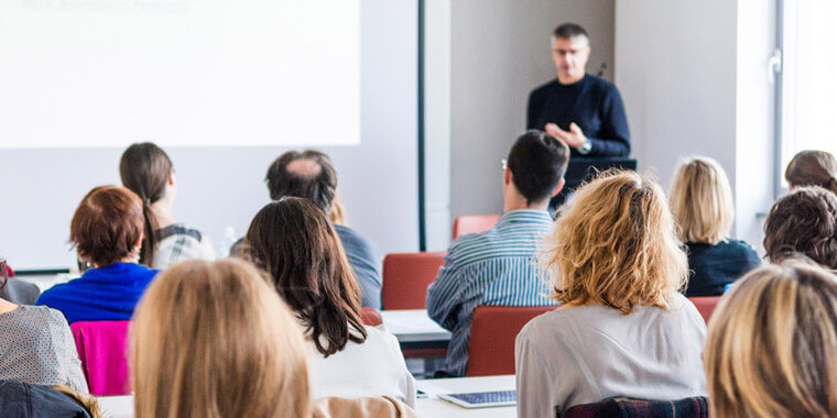 group of people listening to a trainer